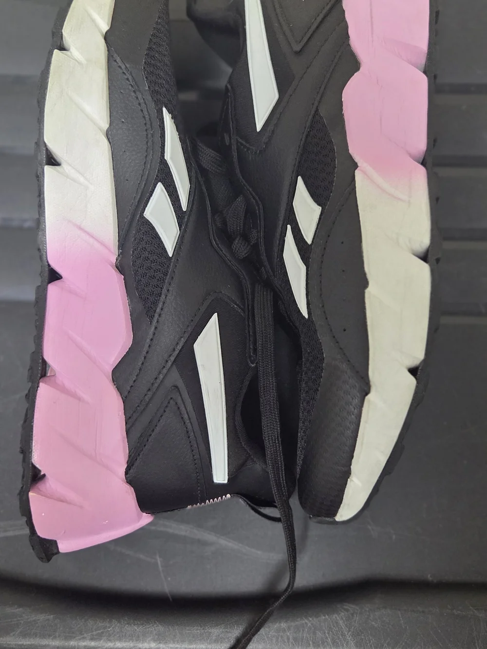Reebok Black Athletic Sneakers with White Stripes and Pink Logo